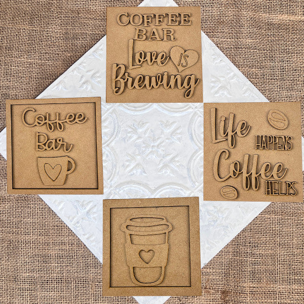 Create your own cozy décor with Janet's Craft Corner Coffee Swappable Squares DIY kit—includes four coffee-themed squares with cutout words like "COFFEE BAR" and "Love is brewing," perfect for seasonal home decorating.
