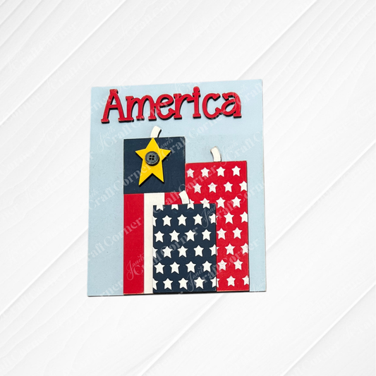 The Patriotic Farmhouse Signs DIY craft kit by Janet's Craft Corner lets you create a handmade card with "America" in red, star-patterned rectangles, and a yellow buttoned star—perfect for tiered tray decor. Set of 1.