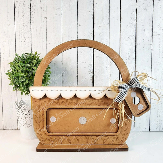 The Basked Interchangeable Base by Janet's Craft Corner is a 3-piece DIY seasonal home decor kit—perfect for holding tissues and displaying beside plants, with options for interchangeable inserts to match any occasion.