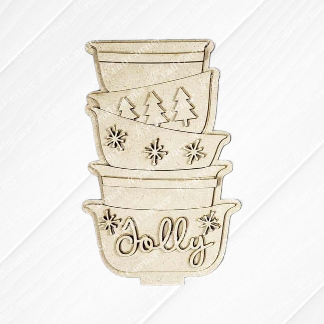Janet's Craft Corner Christmas Baking Mini Shelf Sitter—a DIY seasonal home decor kit featuring a beige bowl stack with festive engravings: plain, pine trees, snowflakes, and "Jolly," displayed on a white wood background. Set of 1.