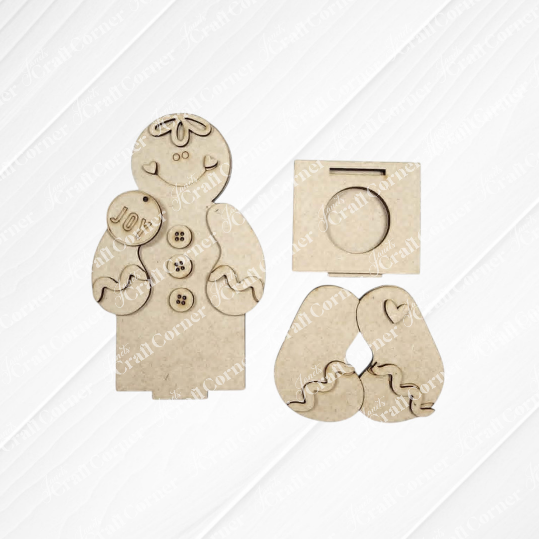 Introducing Janet’s Craft Corner’s Snowman & Gingerbread Votive Holder Shelf Sitter – a DIY home decor craft kit (set of 1) featuring laser-cut MDF pieces, including a “Joy” ornament, buttons, heart shapes, and a square stand for simple assembly. Perfect as charming Christmas shelf decor, all components are shown on a light background and create delightful votive holder shelf sitters for your holiday home.
