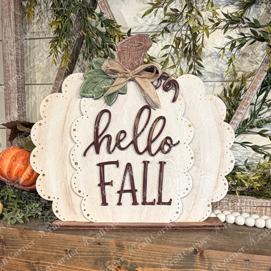 The Hello Fall Pumpkin Shelf Sitter from Janet’s Craft Corner is a DIY home decor craft kit featuring a wooden, pumpkin-shaped sign with “hello FALL” written on it. Surrounded by autumn leaves, greenery, and a small orange pumpkin, this set of 1 is perfect as a charming shelf accent to enhance your fall décor.