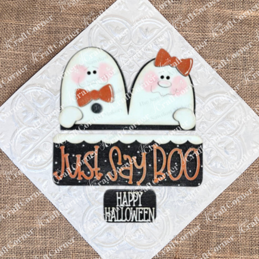 Janet's Craft Corner's Just Say Boo Interchangeable Insert craft kit includes two ghost cookies with orange bows and a sign—perfect DIY Halloween decor or insert for your home, featuring three cute pieces on a textured white background.