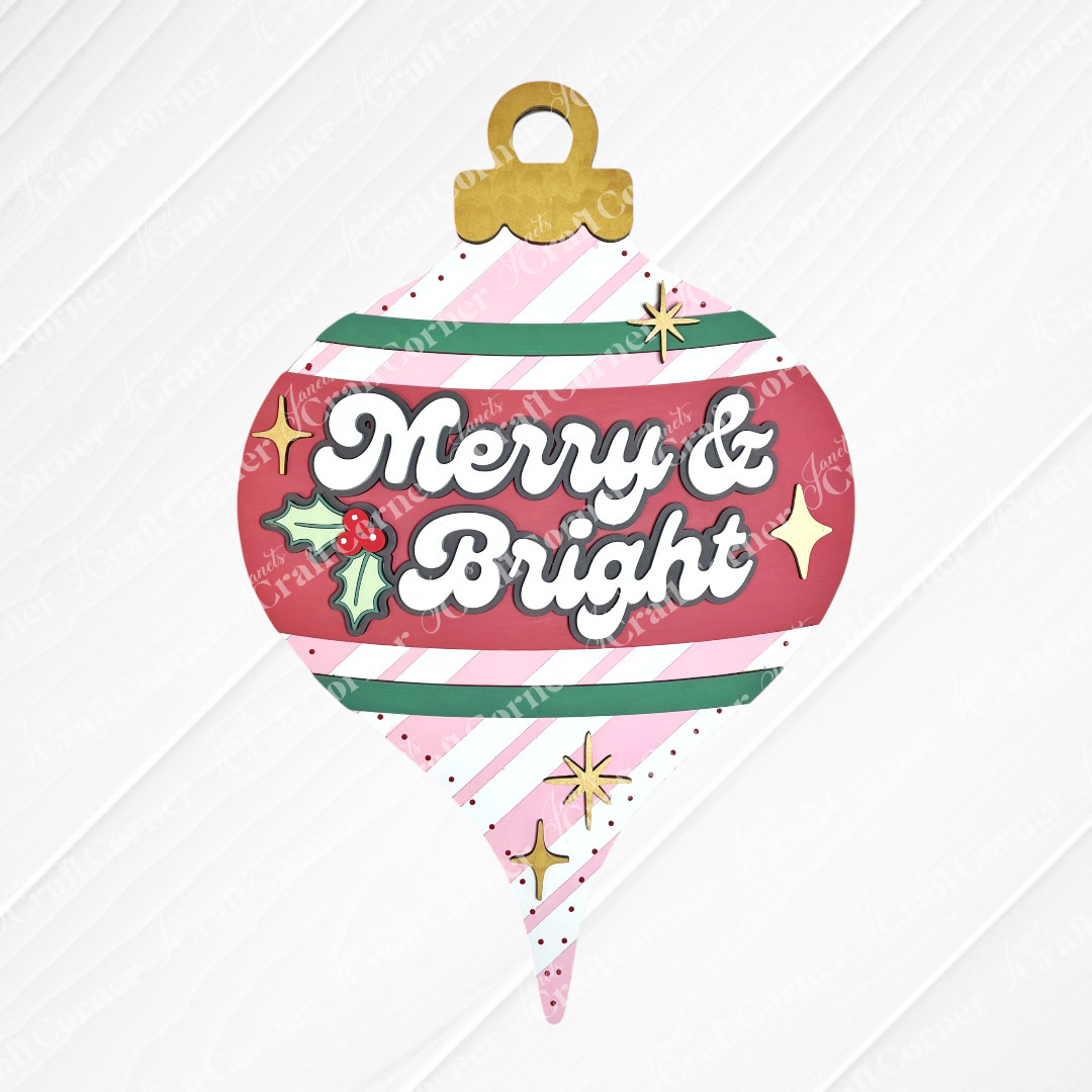 Create a festive holiday display with Janet's Craft Corner Merry & Bright Vintage Ornament Door Hanger DIY kit, featuring white script, holly, gold stars, and colorful stripes—perfect seasonal home decor in one easy kit.