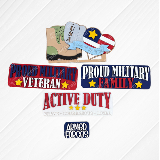 Showcasing military-themed crafts on a burlap background, this DIY home decor kit includes an interchangeable display that features a USA sign with a boot and the text "Home of the Brave." Created by Janet's Craft Corner, this hand-painted Military Interchangeable Insert also has badges reading "Proud Military Veteran" and "Proud Military Family.