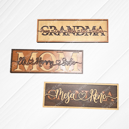 The Personalized Mom Sign by Janet's Craft Corner features three rectangular wooden plaques with layered names and heart accents, creating a charming custom mom gift, beautifully displayed on a white wood-textured background.