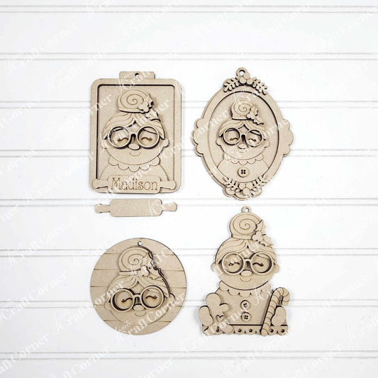 Set of four Mrs. Claus Ornaments from Janet's Craft Corner, each with glasses and a bun in assorted shapes (clipboard, oval frame, circle, candy cane stand). Ideal for festive decor or DIY crafts. One ornament labeled "Madison.