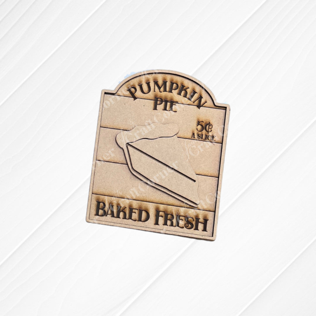 The Thankful Mini Shelf Sitters from Janet's Craft Corner is a DIY decor craft kit featuring a wooden sign engraved with "Pumpkin Pie," "5¢ a slice," and "Baked Fresh," perfect for adding charm to your seasonal home.