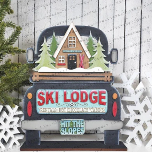 The Ski Lodge Interchangeable Insert by Janet's Craft Corner features a vintage truck with a ski lodge scene and is perfect for DIY seasonal home decor kits. Includes 1 set of 3 pieces for use with interchangeable inserts.