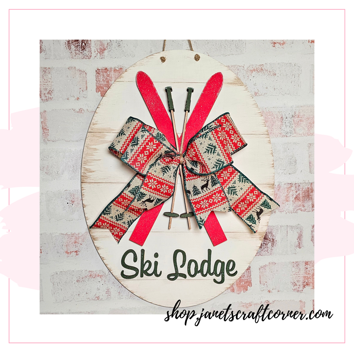This Ski Lodge Door Hanger features red skis, poles, and a festive bow on wood, with "Ski Lodge" in green script. Ideal for home décor, find it as part of the DIY craft kit at Janet's Craft Corner: shop.janetscraftcorner.com.