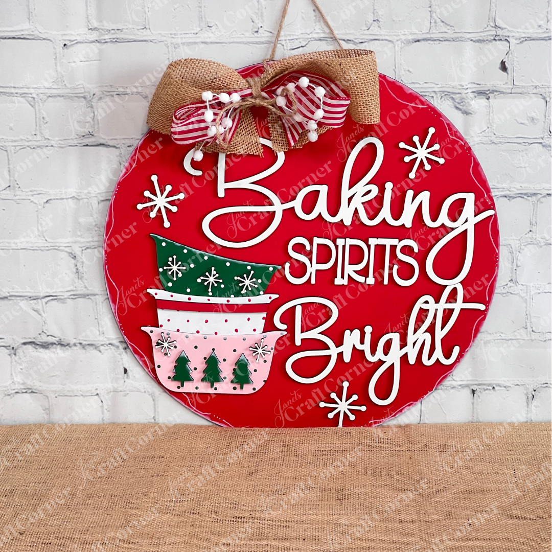 Add a festive touch to your space with the Heartland Baking Spirits Bright Bowls Door/Wall Hanger—a painted red, round sign featuring stacked holiday bowls, snowflakes, and the cheerful phrase “Baking Spirits Bright,” finished with a decorative bow. Perfect as Christmas door decor or charming holiday baking wall art, this piece brightens up any white brick wall.