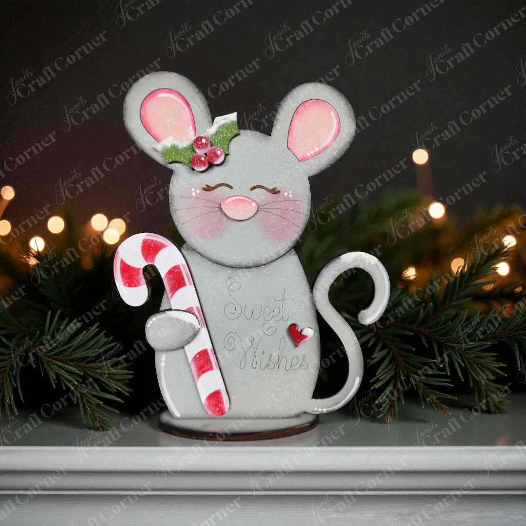 The Forest Friends Shelf Sitters DIY craft kit from Janet's Craft Corner features a mouse figurine with a candy cane, holly, and "Sweet Wishes," perfect for adding woodland charm to your holiday decor. Choice of 3 designs included.