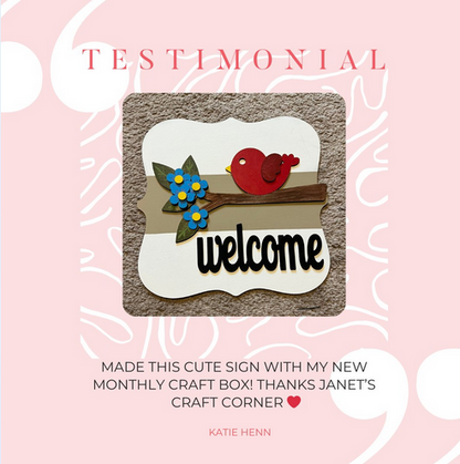 The Bird Welcome Sign by Janet's Craft Corner features a red bird on a branch with blue flowers, "welcome" elegantly below. It's highlighted as an entryway craft box creation against a "Testimonial" background.