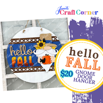 Round gnome-themed door hanger on a blue background, featuring "hello FALL" text and a gnome holding a pumpkin. Promo: "Hello Fall Gnome Door Hanger DIY Kit" for $20 with Janet's Craft Corner logo—a perfect seasonal home décor craft kit!.