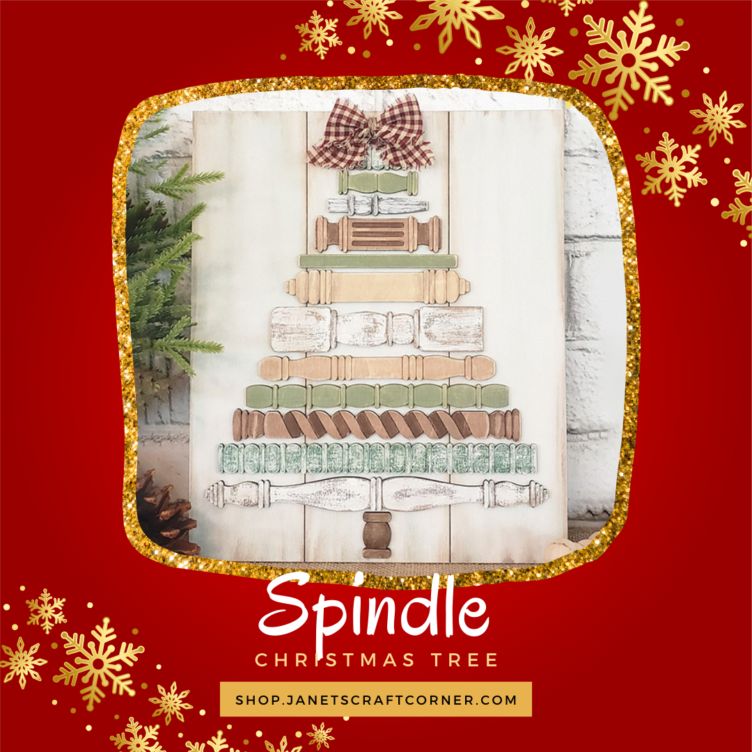 The Spindle Christmas Tree Shelf Leaner DIY craft kit from Janet’s Craft Corner features stacked vintage spindles topped with a plaid bow, displayed on a wooden board and surrounded by gold snowflakes for festive cheer. Set of 1.
