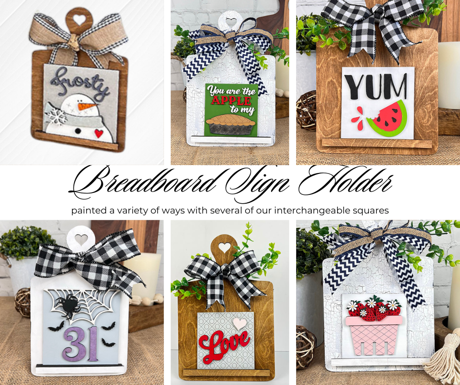 Janet's Craft Corner Breadboard Swappable Squares Holder DIY Craft Kit Set features a holder with interchangeable square signs—snowman, apple, watermelon, spider, “Love,” and floral designs—each topped with a checkered bow for festive seasonal décor.