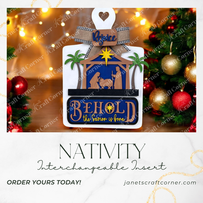 A festive ad for Janet's Craft Corner's Nativity Interchangeable Insert features "Behold, the Savior is born" and "Rejoice" and showcases holiday lights and ornaments. Available at janetscraftcorner.com.
