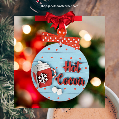 Add a cozy touch to your Christmas décor with Janet's Craft Corner's Hot Cocoa Round Ornament. Featuring blue with red polka dots, a hot cocoa mug, and a red bow, this DIY kit creates the perfect festive ambiance against blurred lights. Set includes 1 ornament.