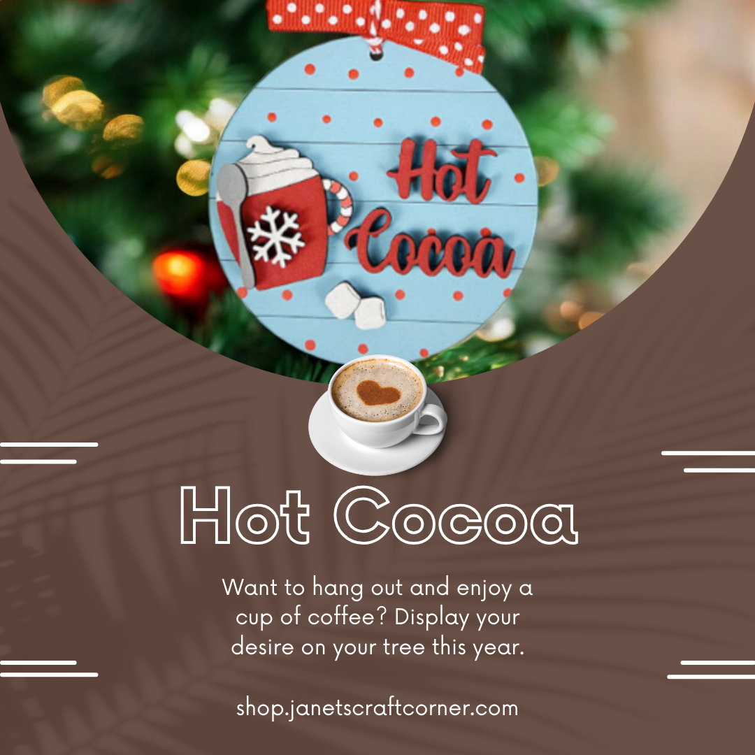 Enhance your home décor with our "Hot Cocoa Round Ornament," featuring a blue ornament marked with "Hot Cocoa," a snowflake, and cocoa topped with heart-shaped foam. Available at Janet's Craft Corner: shop.janetscraftcorner.com.
