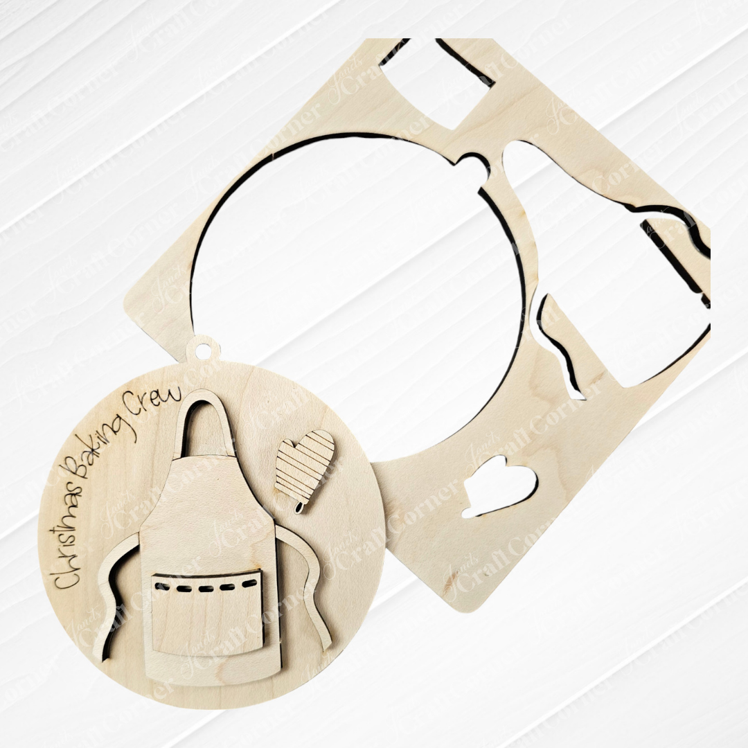 Janet's Craft Corner offers the Baking Ornaments - Set of 2, providing DIY craft enthusiasts with a wooden ornament kit featuring a round frame that reads "Christmas Baking Crew." This set includes cut-out shapes of an apron, heart, and mitten on a white background, making it perfect for festive home décor.