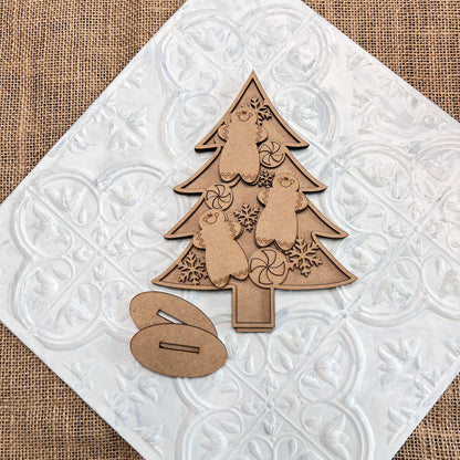 Capture the holiday spirit with Janet's Craft Corner's Standing Christmas Tree Shelf Sitters. These charming wooden ornaments, featuring intricate bear and snowflake cutouts, are set against a textured white tile background. A small wooden accent piece sits nearby on a burlap surface, making it an ideal choice for a festive shelf display.
