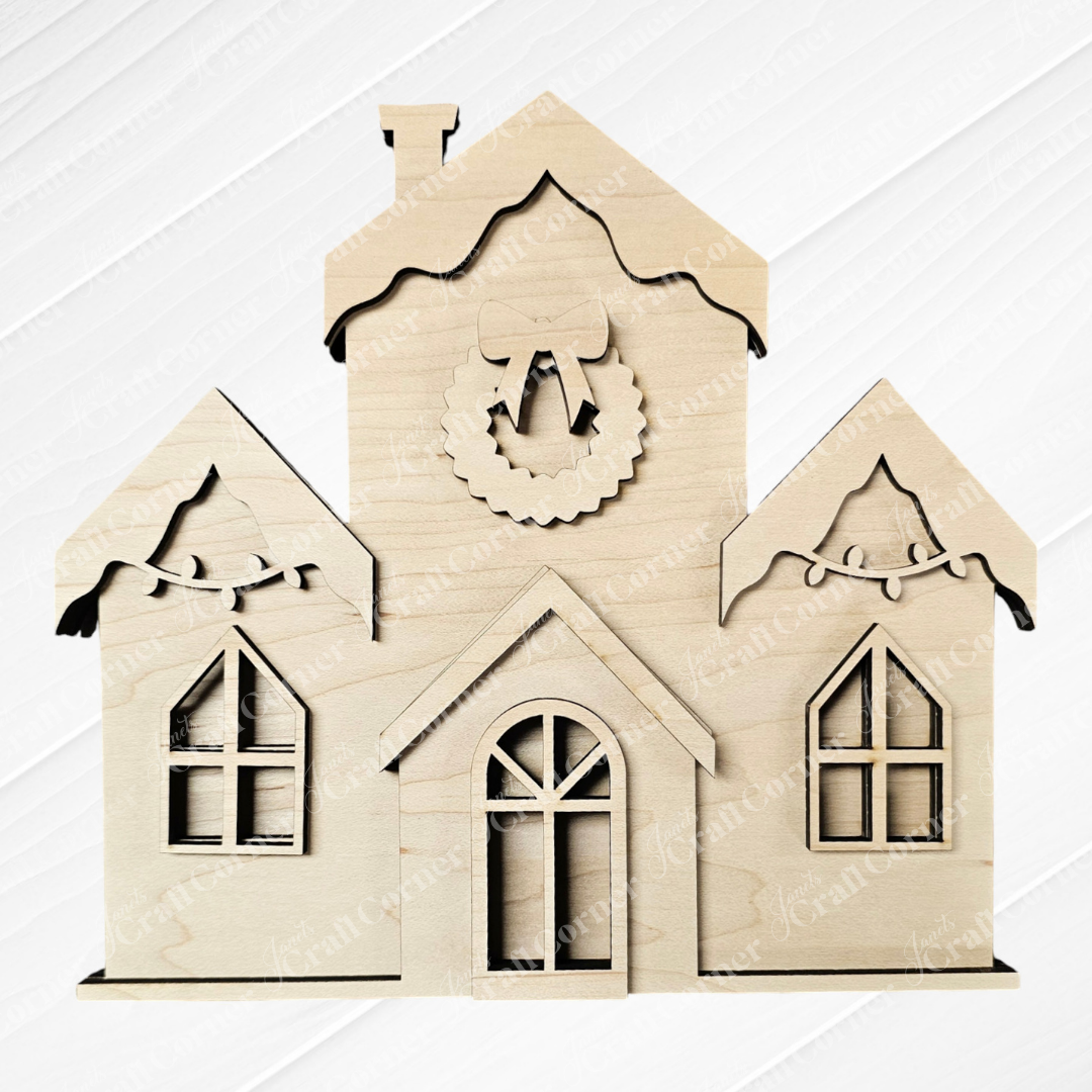 Wooden cutout of a house with three gables and arched windows, highlighted by a central wreath. This piece from Janet's Craft Corner, similar to the Christmas Village Shelf Sitters - Set of 4 in Early Access, displays light-colored wood against a white, textured background.