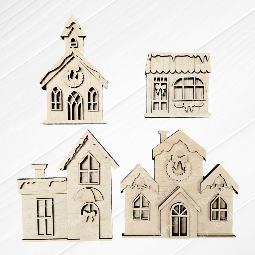 This delightful set from Janet's Craft Corner, the Christmas Village Shelf Sitters - Set of 4, features charming wooden cutouts of four small buildings, including a church and a house adorned with windows. With decorative facades and a wreath above the door of one house, these shelf sitters add cozy charm against their light wooden background.