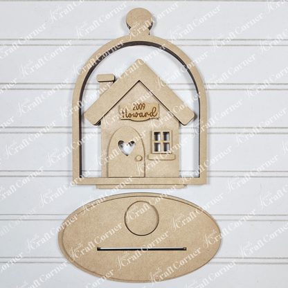 The "Home Cloche Votive Holder Shelf Sitter" by Janet's Craft Corner is a wooden cutout of a house engraved with "2009 Howard," set in a cloche-shaped frame. It features an oval plaque against a lined white background, perfect for DIY craft kit enthusiasts seeking unique home decor.