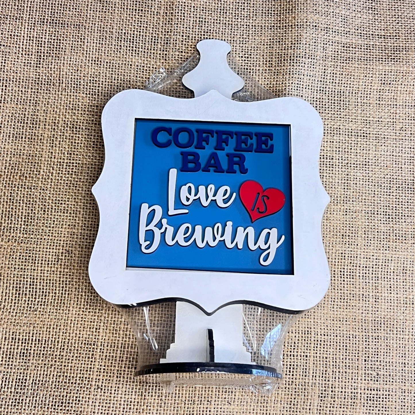 The Heartland Drop In Swappable Squares Holder DIY Craft Kit is a charming wood display with a white frame and base, perfect for coffee nooks. Add your own decorative signs to customize your space! Set of 1.