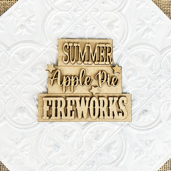 Janet's Craft Corner offers the Summer Word Stacks, featuring wooden cutouts with the words "SUMMER," "Apple Pie," and "FIREWORKS" on a white textured background. Enhanced with small star shapes, this set is ideal for DIY kit enthusiasts and fans of farmhouse-style decor.