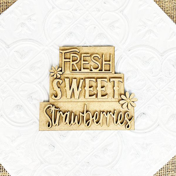 Introducing the "Summer Word Stacks" by Janet's Craft Corner, a farmhouse-style decorative wooden sign adorned with charming flower designs and proclaiming "Fresh Sweet Strawberries" in various styles and sizes. The white textured background creates a subtle pattern, making it perfect for summer-themed word stacks or as a delightful DIY kit project.