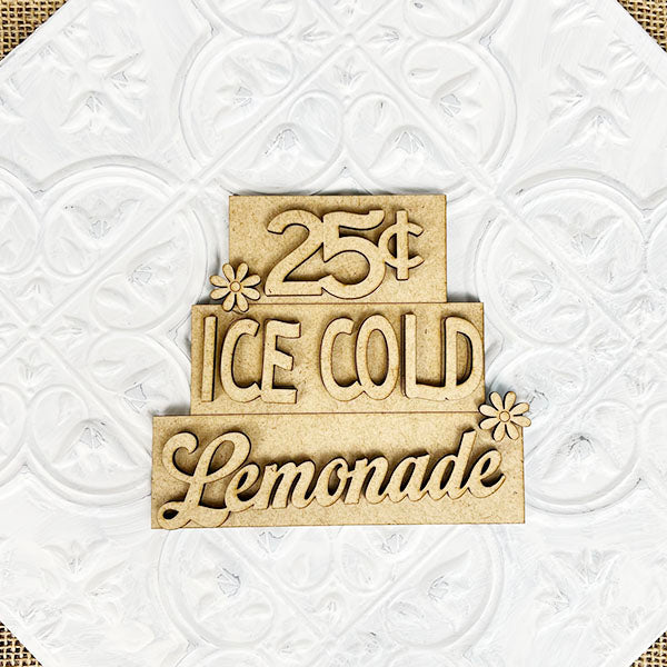 The "Summer Word Stacks" by Janet's Craft Corner is a decorative wooden sign ideal for farmhouse-style decor, featuring the phrase "25¢ ICE COLD Lemonade" adorned with floral accents. This delightful sign, set against a patterned white background, adds a charming touch to any space.