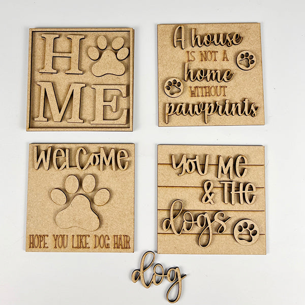 Introducing the Dog Interchangeable Squares by Janet's Craft Corner, these charming wooden mini signs are perfect for farmhouse decor. They feature delightful dog-themed quotes such as "Home" with a paw, "A house is not a home without pawprints," "Welcome, hope you like dog hair," and "You, me & the dogs." A small "dog" cutout at the bottom adds a whimsical touch.