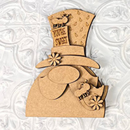 This charming 3D wooden cutout from Janet's Craft Corner, known as the Watermelon Shelf Sitters, features a figure with a tall hat adorned with daisy-like flowers and small sheep details. Perfect for farmhouse decor, the hat proudly displays "You're Sweet," while a white embossed pattern in the background adds to its inviting rustic charm.