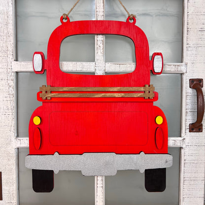 The Antique Truck Interchangeable Base - Painted by Janet's Craft Corner is a wooden red truck decor with yellow tail lights and a silver bumper, ideal for hanging on doors with white window panes as versatile, charming décor.
