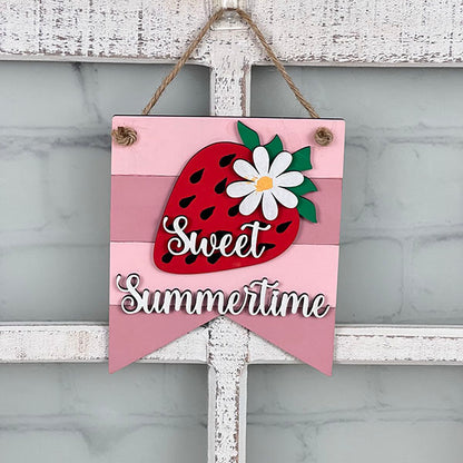 A charming handcrafted sign from Janet's Craft Corner, shaped like a banner, hangs on a white window frame. It's perfect for summer home decor with its vibrant features of a large strawberry and a white flower set against a pink striped background. The words "Sweet Summertime" are elegantly written in white script, reflecting the delightful essence of Summer Mini Signs.