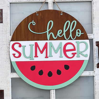 Product Description: The Hello Summer Watermelon Round by Janet's Craft Corner is a delightful round wooden sign featuring "hello SUMMER" in vibrant teal, red, and white colors, adorned with a whimsical watermelon design. Ideal for hanging on rustic white doors, this charming piece of home décor adds a cheerful ambiance to any space. Perfect for craft enthusiasts interested in DIY kit projects.