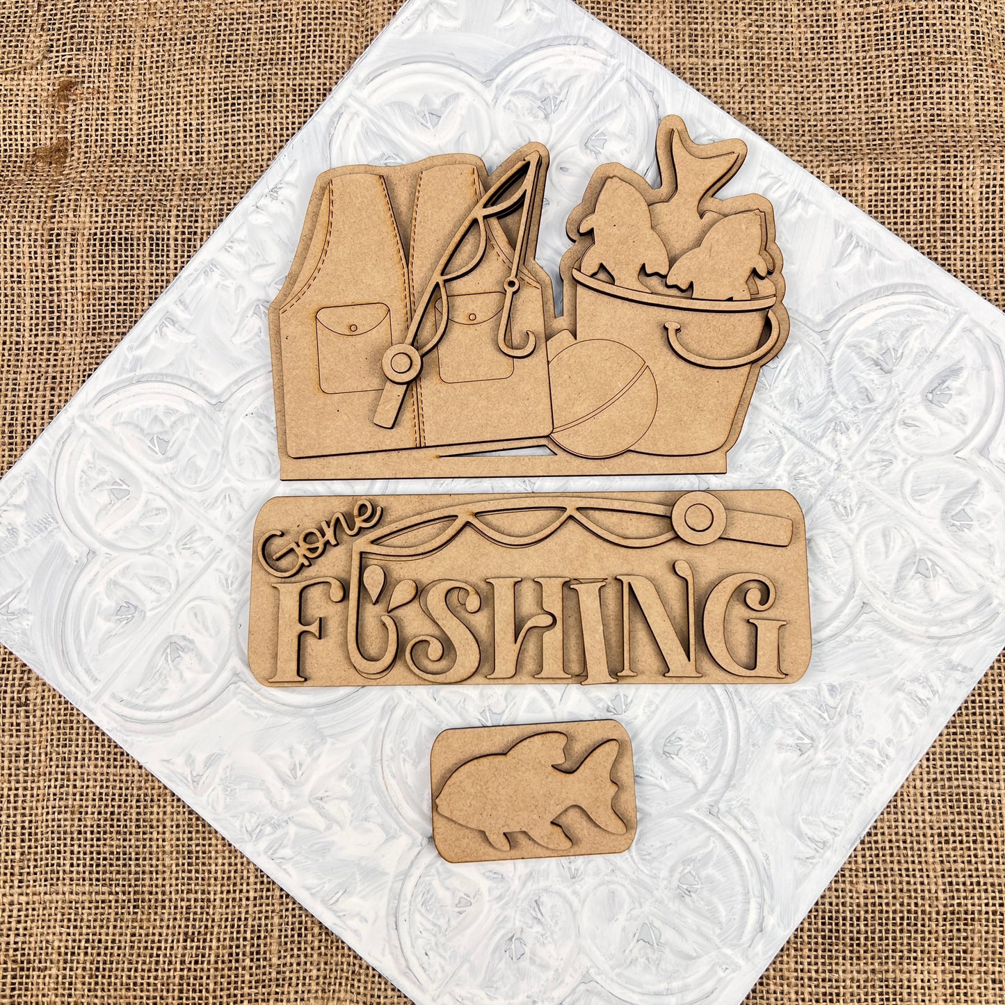 The Gone Fishing Interchangeable Insert by Janet's Craft Corner is a 3-piece DIY seasonal home decor kit with laser-cut wooden pieces—perfect for your crafting projects.
