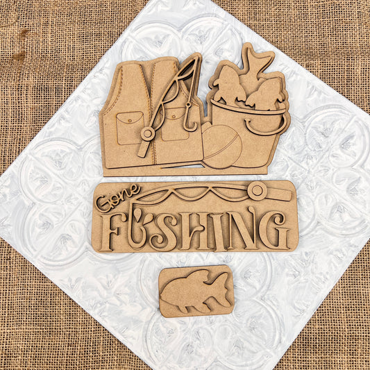 The Gone Fishing Interchangeable Insert by Janet's Craft Corner is a 3-piece DIY seasonal home decor kit with laser-cut wooden pieces—perfect for your crafting projects.