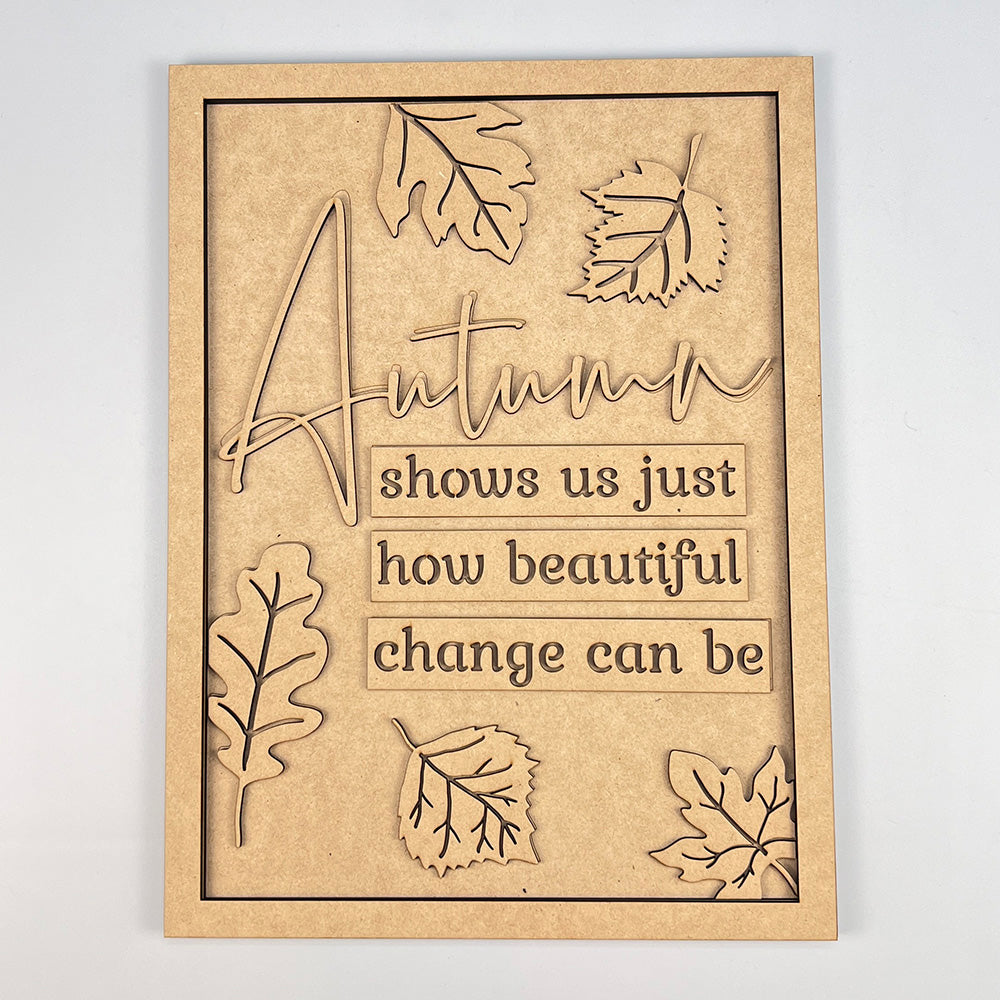 The Autumn Change Shelf Leaner DIY Home Decor Kit from Janet's Craft Corner includes a wooden sign adorned with the quote "Autumn shows us just how beautiful change can be," surrounded by intricately carved leaves. This kit is perfect for enhancing your home décor, as it seamlessly merges nature's beauty with thoughtful design.