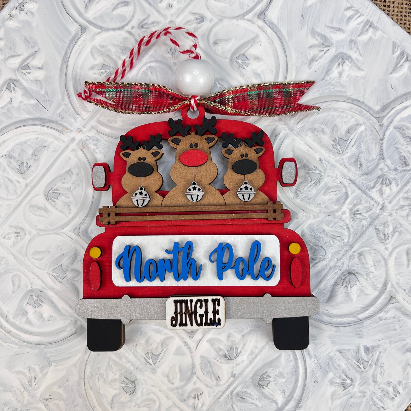 Experience nostalgic charm with Janet's Craft Corner's Antique Truck Ornament - Painted, featuring a classic red truck adorned with festive reindeers.