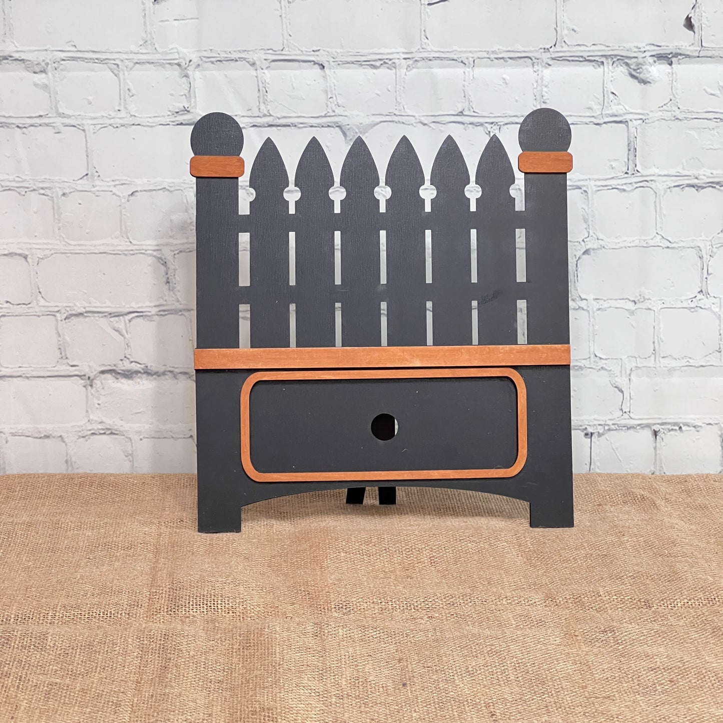 The Garden Fence Interchangeable Base - Painted by Janet's Craft Corner is a decorative dark gray wooden box with orange-brown trim, ideal for DIY home decor or as part of a craft kit for interchangeable inserts.