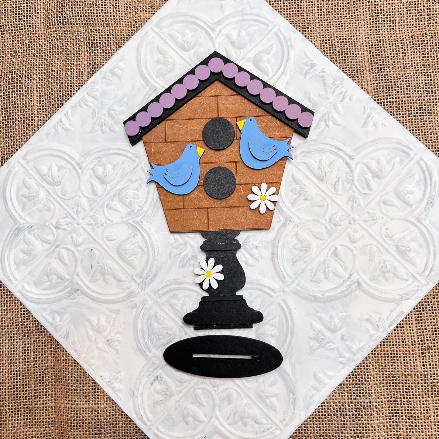 Janet's Craft Corner's Spring Mini Shelf Sitters - Painted features a brown birdhouse, two blue birds, and white daisies on an embossed background with burlap trim—ideal spring decor or for pairing with gnome shelf sitters.