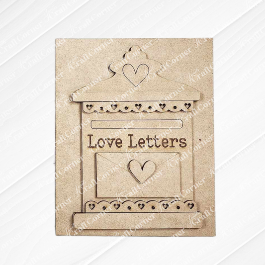 The "Love Letters Mailbox" by Janet's Craft Corner is a DIY craft kit featuring a wooden decorative piece with heart cutouts and engraved "Love Letters." Hand-painted on a textured white background, it adds charm to interchangeable home decor.