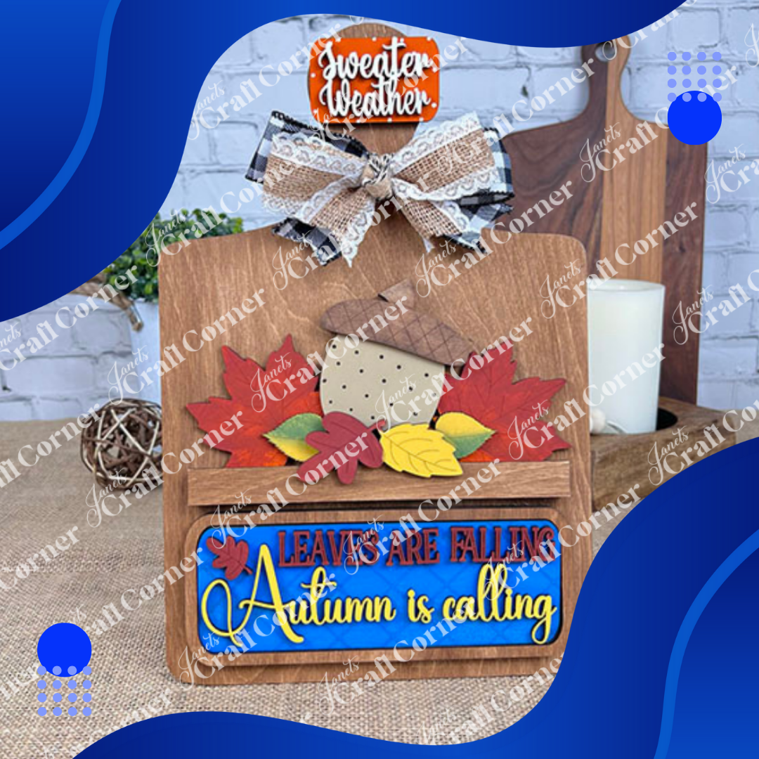 Autumn-themed decorative sign with leaves and text on a wooden board.