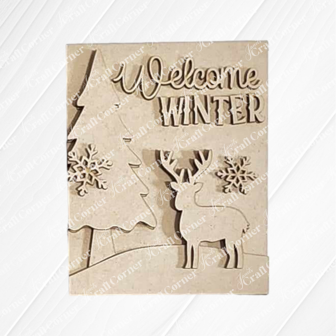 The Welcome Winter Sign from Janet's Craft Corner is a hand-painted wooden plaque showcasing "Welcome Winter" text, adorned with a tree, two snowflakes, and a reindeer. It's an ideal piece of charming home decor to celebrate the season's arrival.