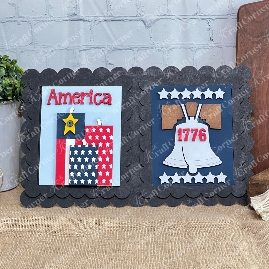Janet's Craft Corner Patriotic Farmhouse Signs DIY kit features "America" in red with stars and a Liberty Bell marked "1776" on a black scalloped frame with white stars—perfect seasonal decor for your tiered tray or shelf.