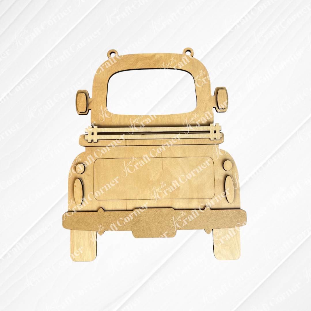 Introducing the "Antique Truck Base with Interchangeable Insert" — a DIY home decor kit by Janet's Craft Corner. This hand-painted set includes a wooden cutout of an antique truck seen from the rear, complete with wheels, a rear window, side mirrors, and lights. The simple yet elegant design features distinct outlines, allowing you to customize your creation with interchangeable inserts.