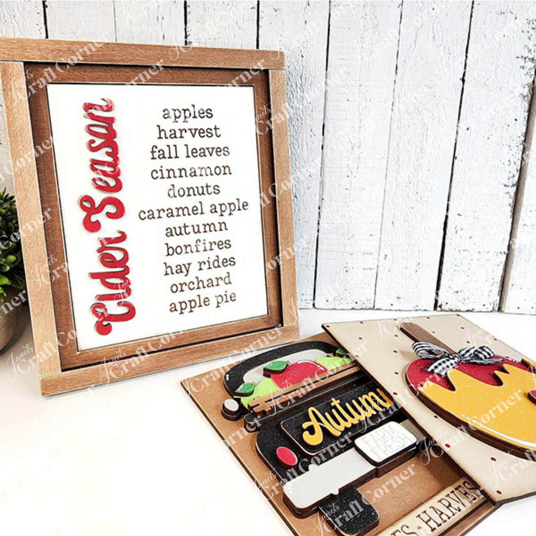 Janet's Craft Corner – Sample painted set of Apple Cider Switchable Farmhouse Signs are DIY seasonal home decor kits with a fall apple theme. One features the wood cut-out word “Cider Season” with words that evoke the scent of apples in the air, another features a caramel apple complete with heart and the last features an antique truck with a load of apples.
