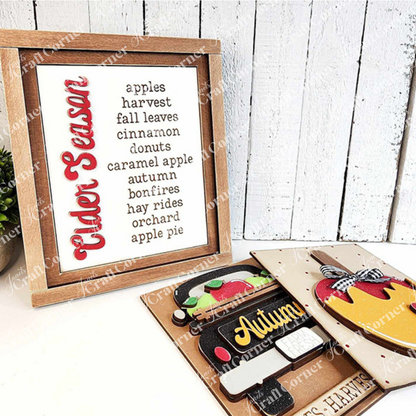 Janet's Craft Corner – Sample painted set of Apple Cider Switchable Farmhouse Signs are DIY seasonal home decor kits with a fall apple theme. One features the wood cut-out word “Cider Season” with words that evoke the scent of apples in the air, another features a caramel apple complete with heart and the last features an antique truck with a load of apples.